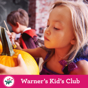Child painting a pumpkin